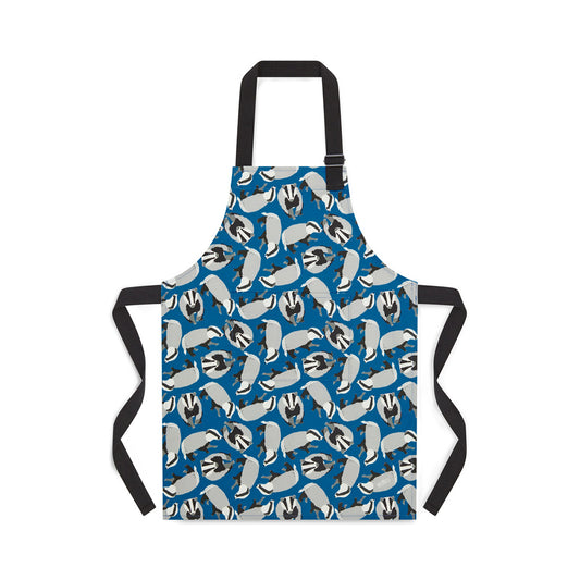 Blue organic Cotton apron featuring badgers illustrations by Ummpixies - shown as worn with pattern matched pocket and black cotton straps with adjustable neck buckle - younger child size shown suitable for up to 5 years