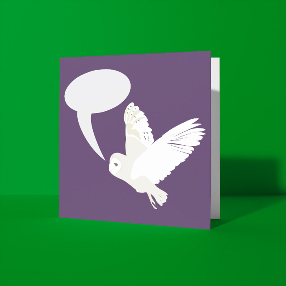 Square, purple greeting card with a white barn owl in flight illustrated with a speech bubble. card shown against a green background.