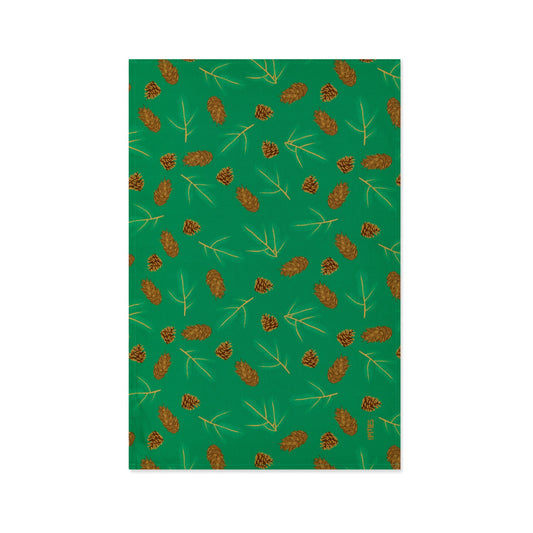 Green Organic Cotton Tea Towel with illustrated Douglas fir cones and spruce sprigs shown lying flat on a white background