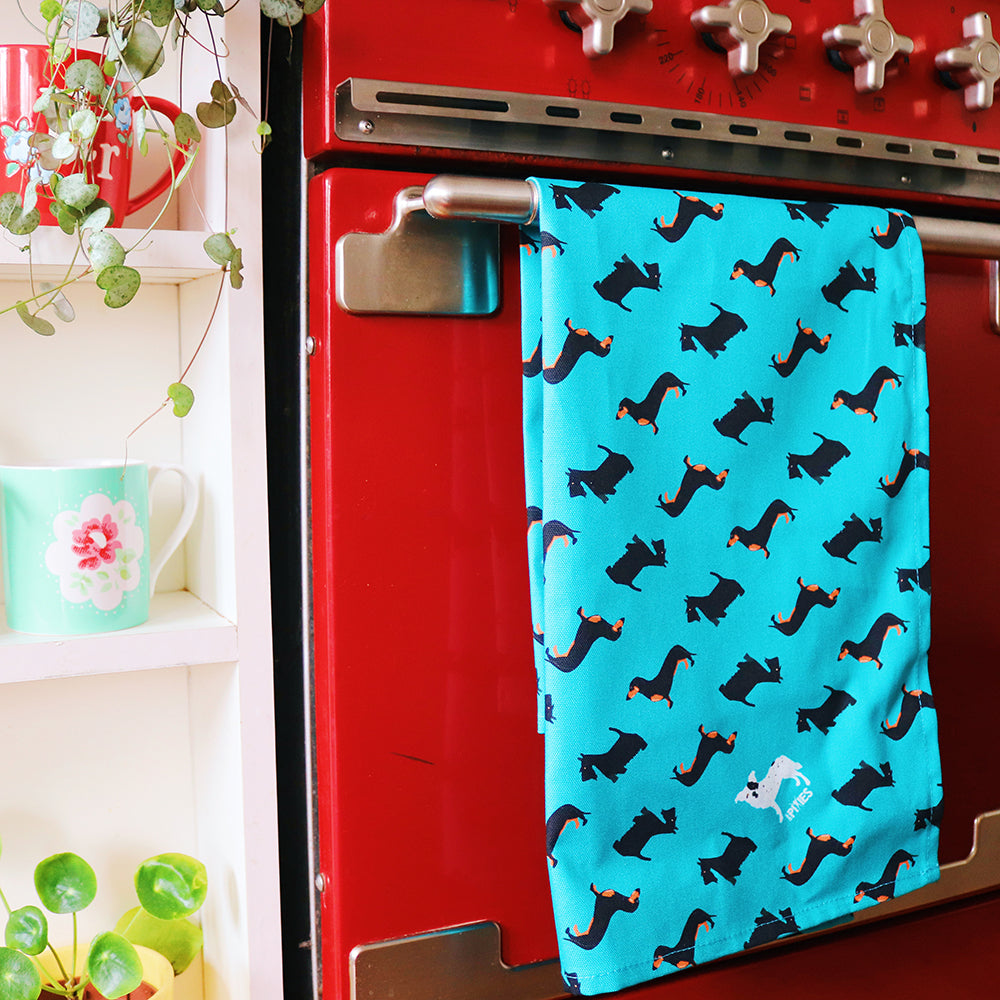 Dogtooth dogs tea towel shown on oven door