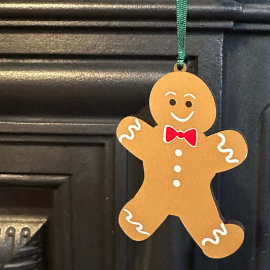 Gingerbread man decoration on a fireplace with a blue wall in the background