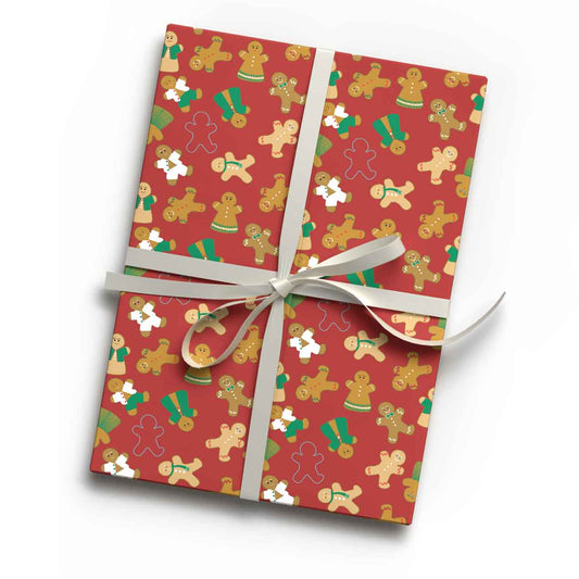 Deep red gingerbread folk biscuit print luxury gift wrap sheet shown wrapping a gift
