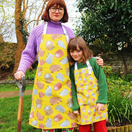 Adult and child wear hedgehog aprons whilst gardening Photo credit @rachelandthelittlebirds