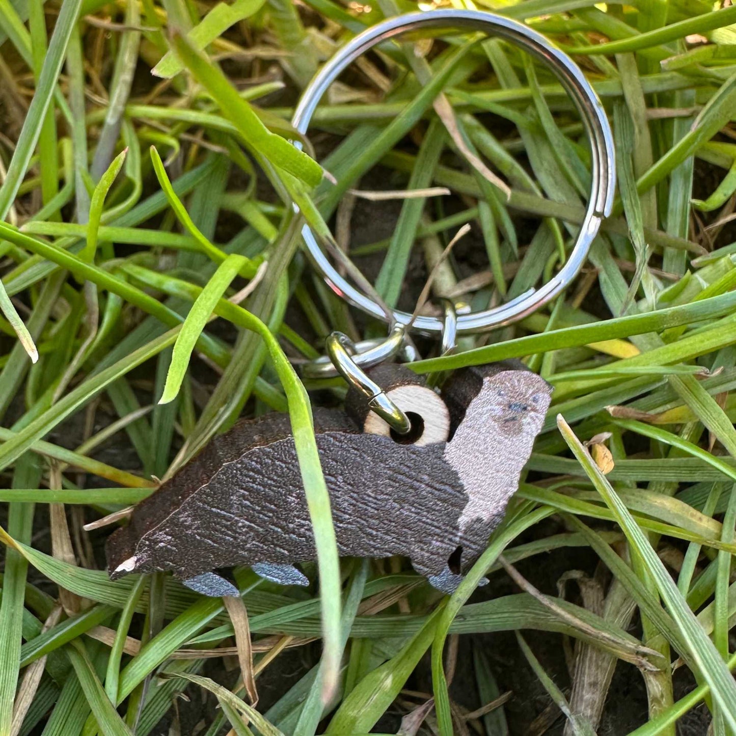 Keychain with otter design on grass