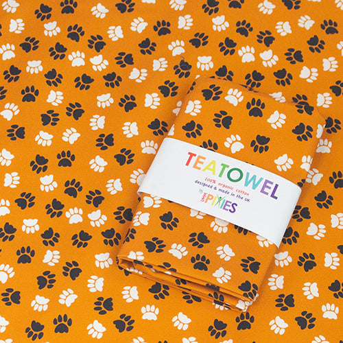Orange Paw Print Tea Towel in organic Cotton from UmmPixies. Designed and made in the UK