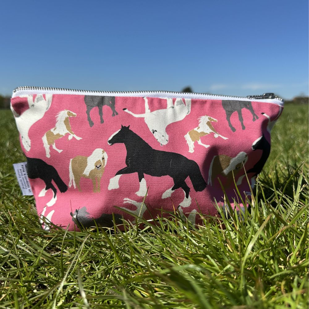 Pinkl Horses Zip Bag shown in a park on a sunny day