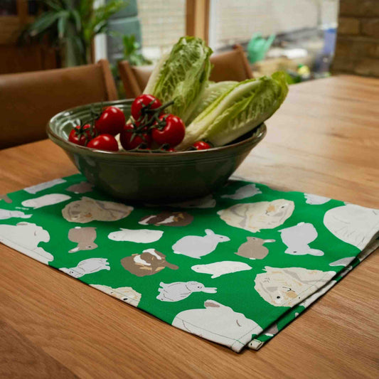Salad bowl on a green tea towel with rabbit design