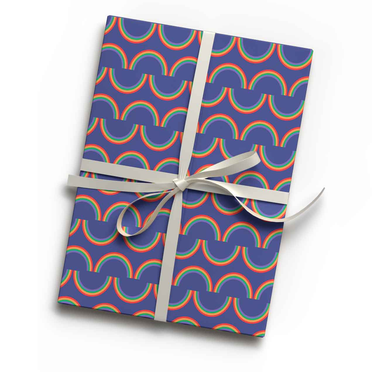 Vibrant rainbow stripe print luxury gift wrap sheet shown wrapping a gift