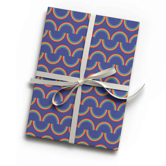Vibrant rainbow stripe print luxury gift wrap sheet shown wrapping a gift