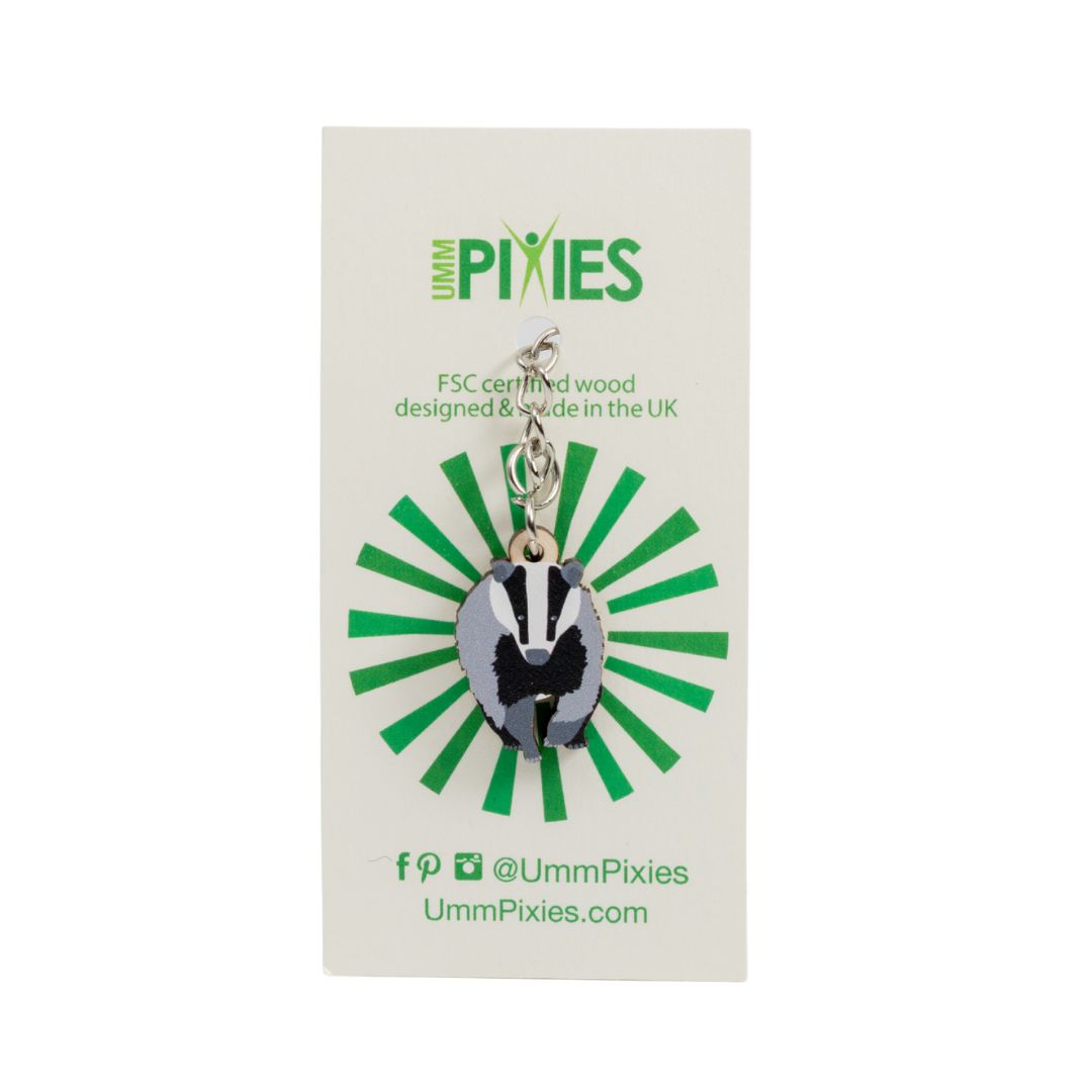 Collectible UmmPixies keychain with wooden badger design charm shown on a branded display card