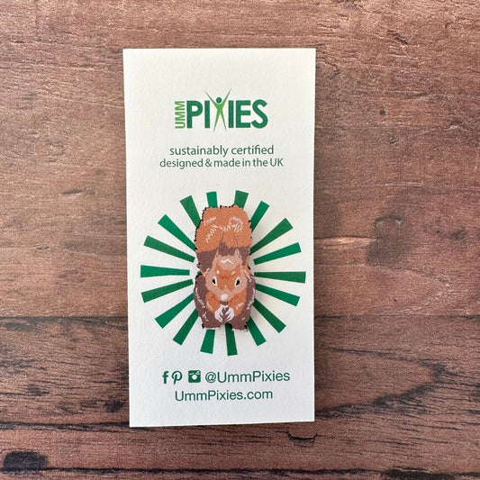 Red Squirrel wooden pin badge on display card on wooden table