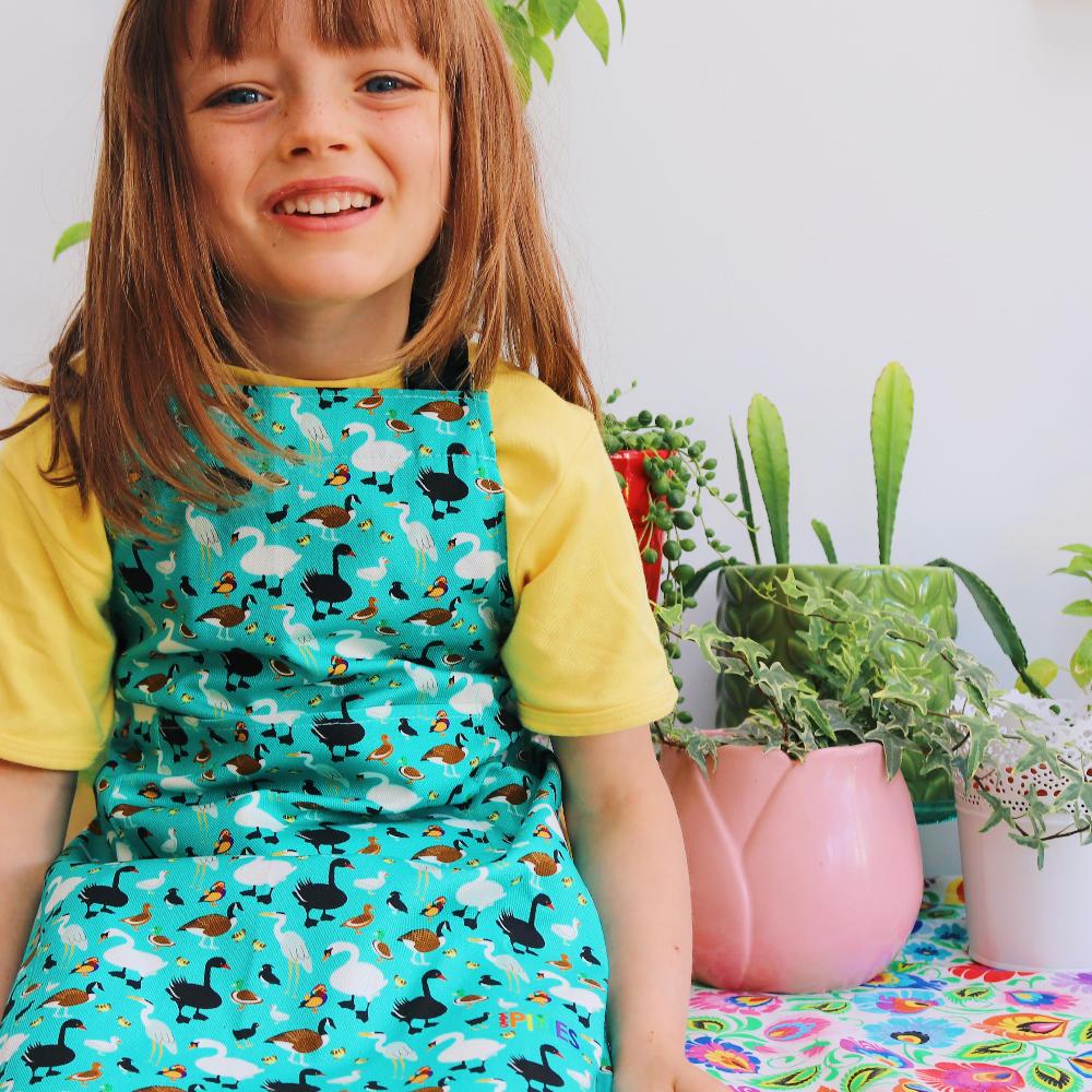colourful cotton apron with Ducks Design - model wears younger child size