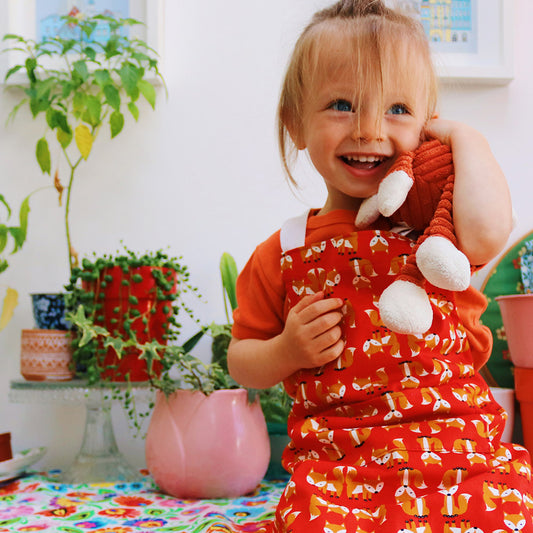 Red Fox Design Organic Cotton Apron - model wears younger child size