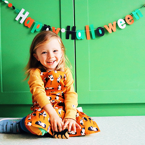 Orange Black and White Cats Design Organic Cotton Apron, model wears younger child size