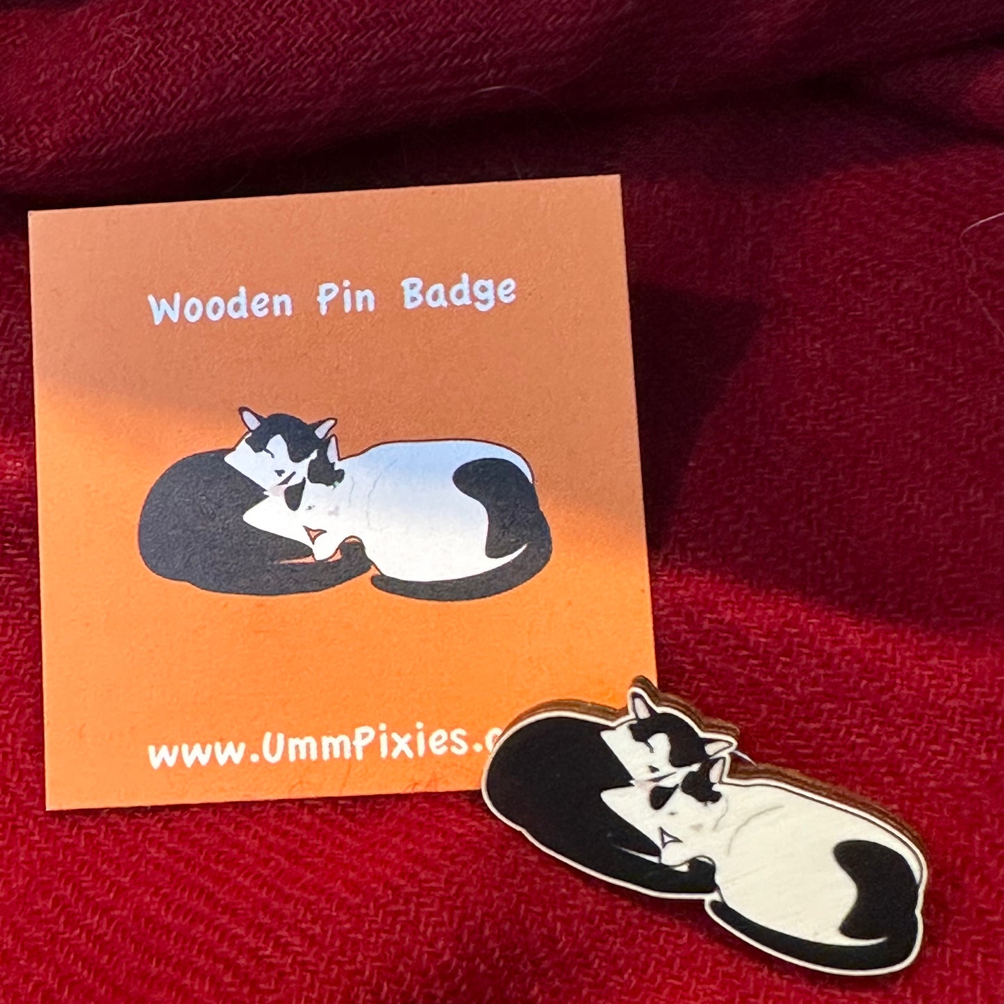 UmmPixies Curled Up Cats Wooden Pin Badge shown next to display card