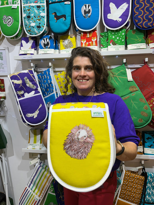 Paula holding sunny yellow hedgehog oven gloves