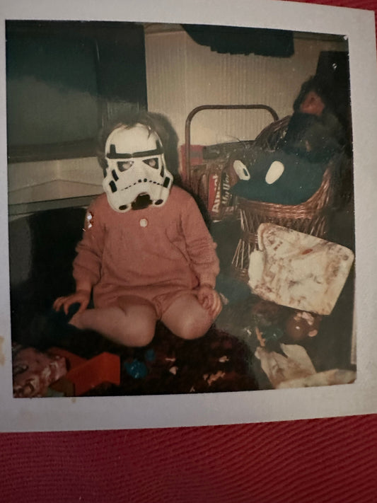 vintage photo of Paula wearing a storm trooper mask on her 5th birthday