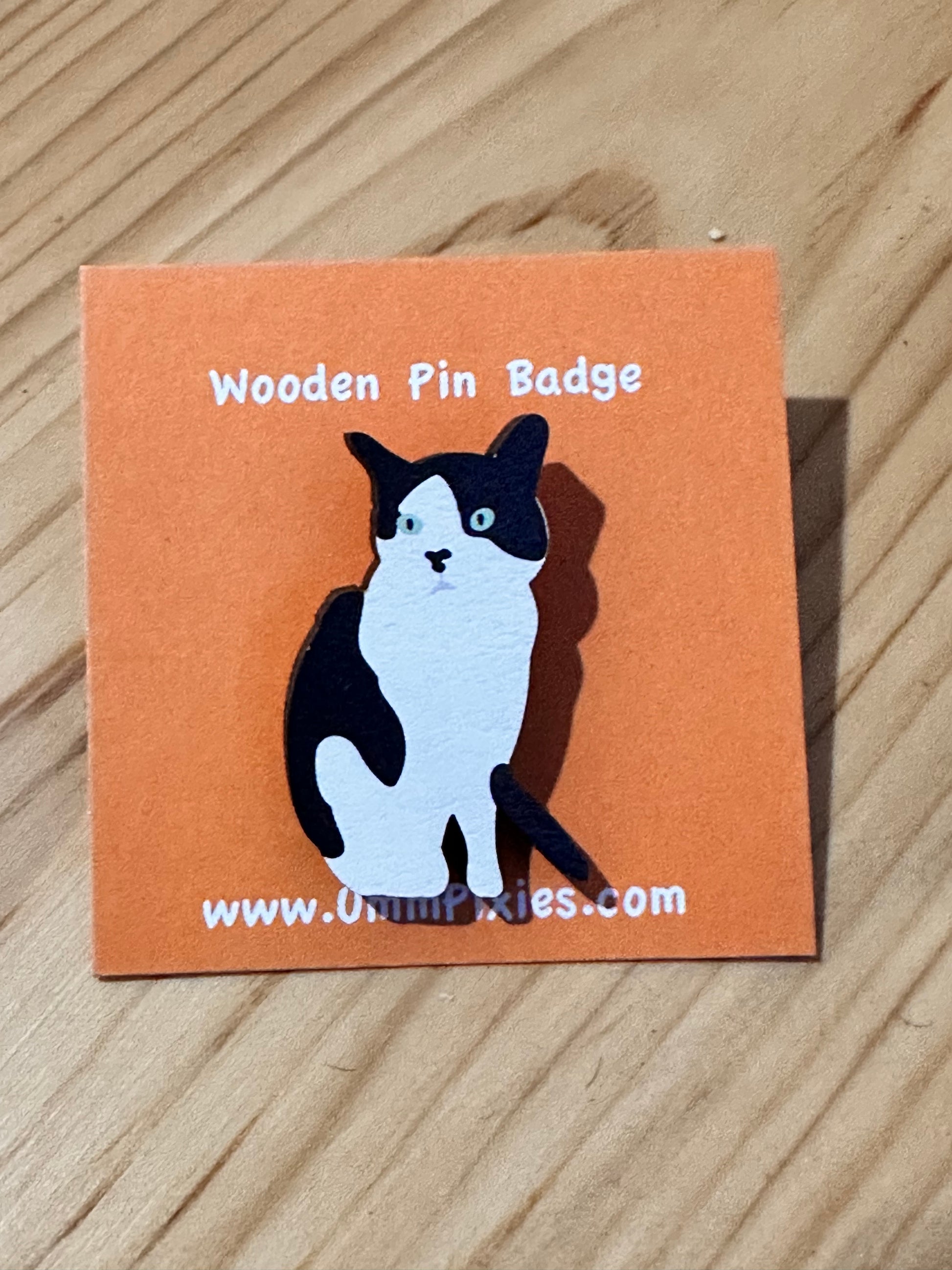 Black and White Tuxedo Cat  pin badge shown on display card
