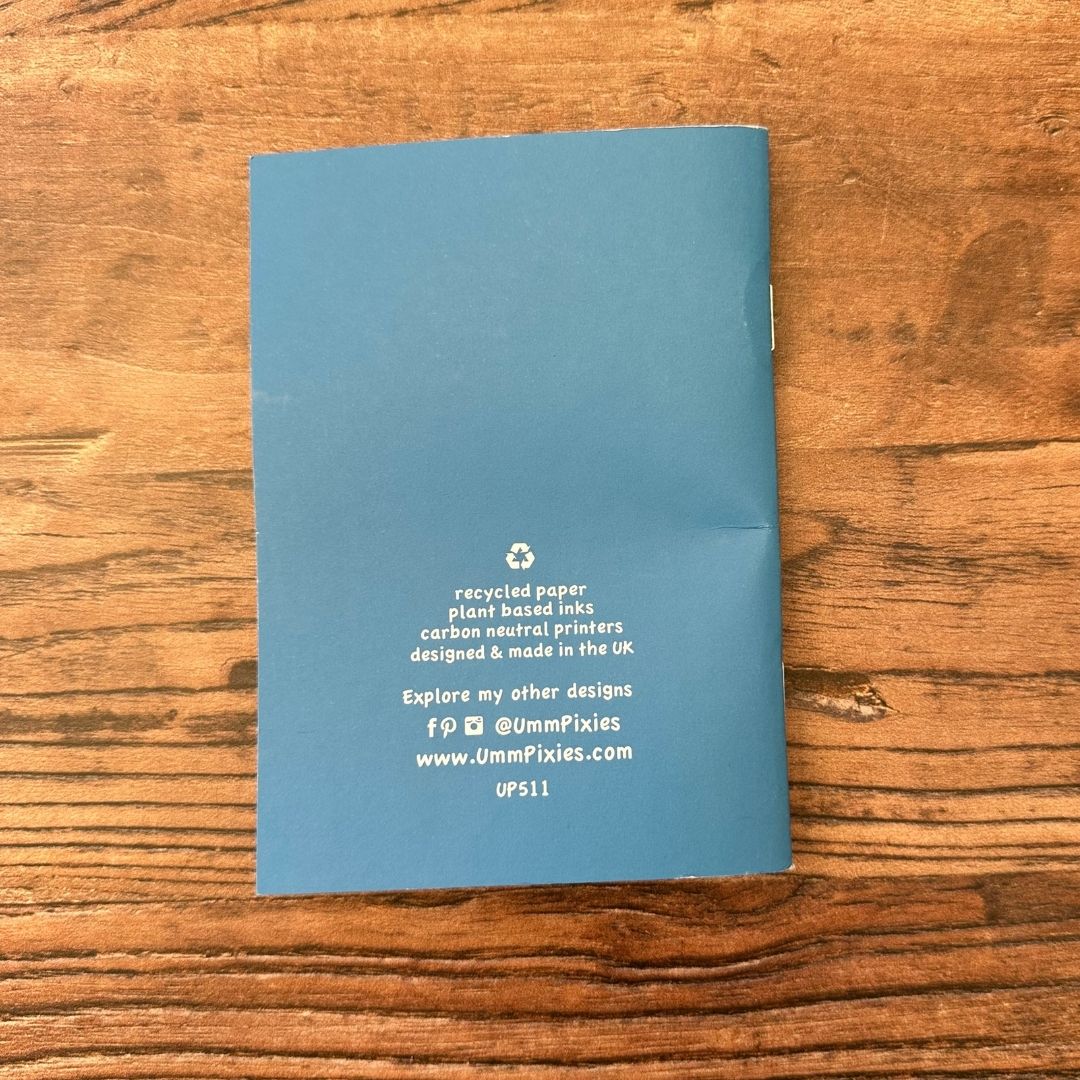Blue notebook with text on a wooden surface