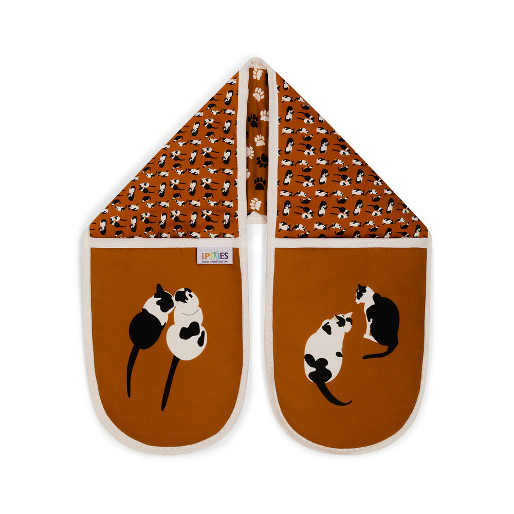 Bright Orange Organic cotton double oven gloves with black and white illustrations of cats and paw prints. Shown here on a plain white background 