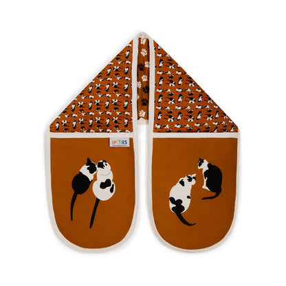 Bright Orange Organic cotton double oven gloves with black and white illustrations of cats and paw prints. Shown here on a plain white background 