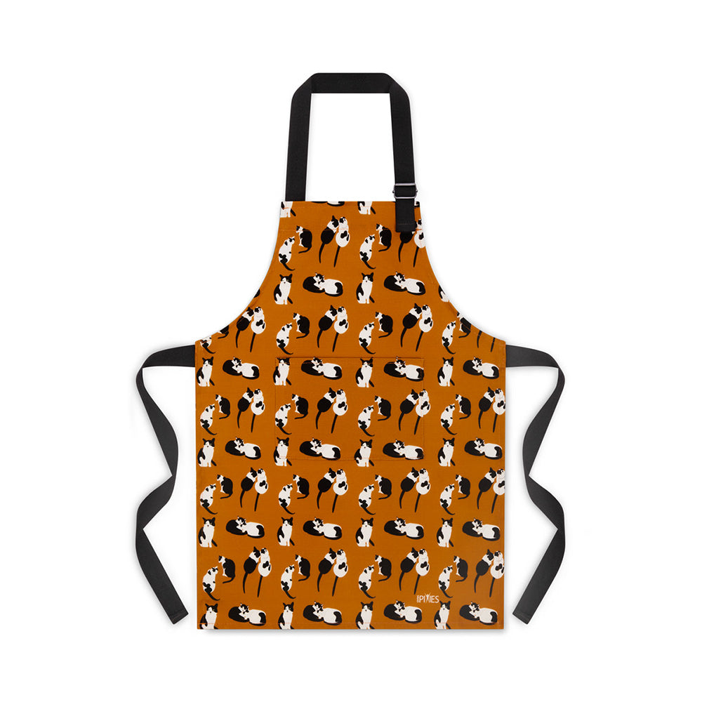 Orange organic cotton apron illustrated with back and white cats print from UmmPixies, cat lovers gift, child size shown pictured with pattern matched pocket and adjustable buckle on neck strap 