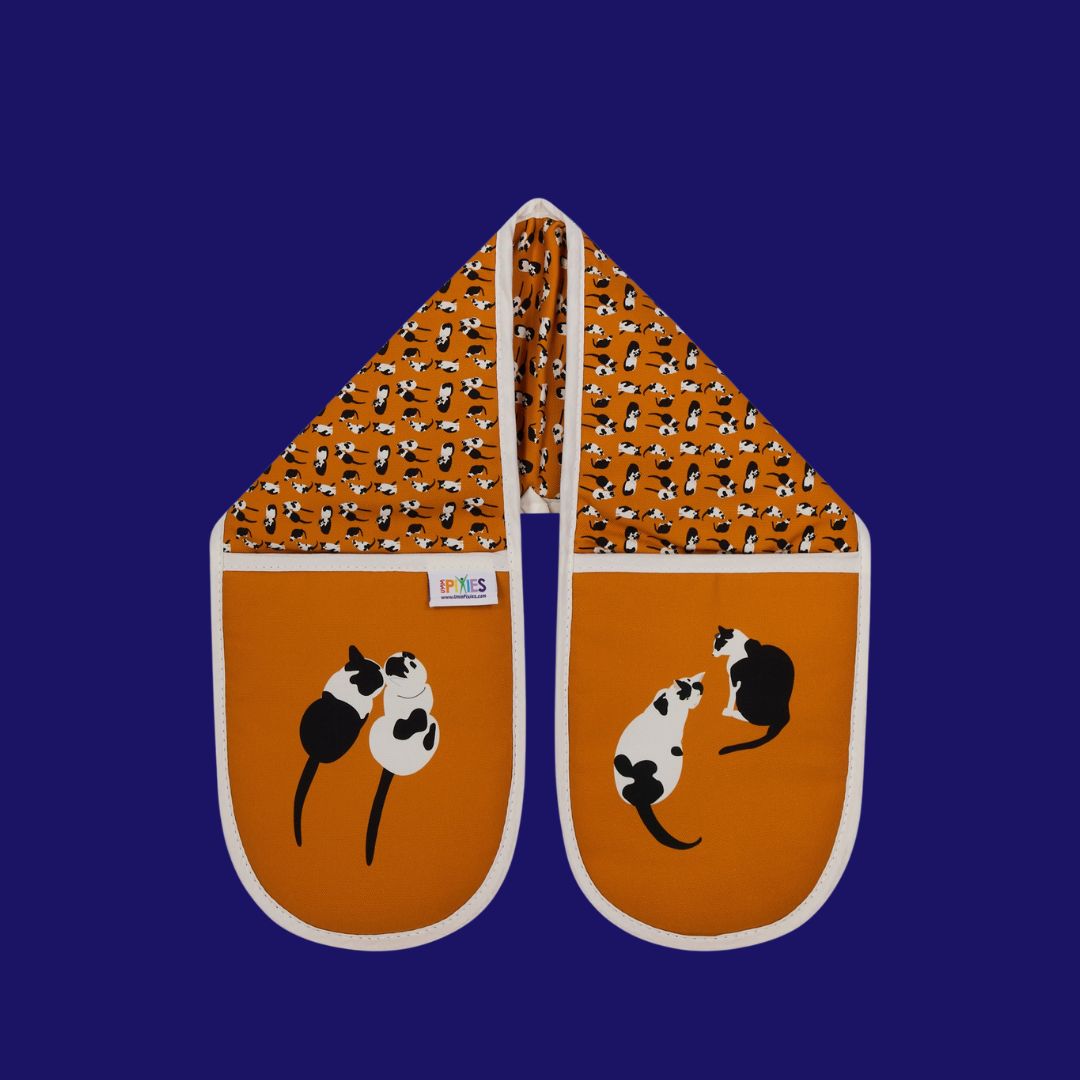 Orange cats oven gloves featuring UmmPixies monochrome moggies design shown on a bright background