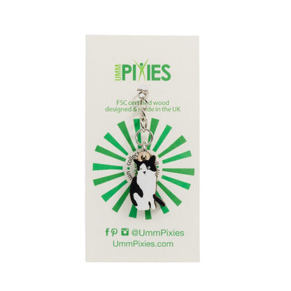 Umm Pixies black and white tuxedo cat wooden keychain on a branded card with green and black design