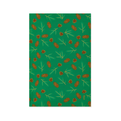 Green Organic Cotton Tea Towel with illustrated Douglas fir cones and spruce sprigs shown lying flat on a white background