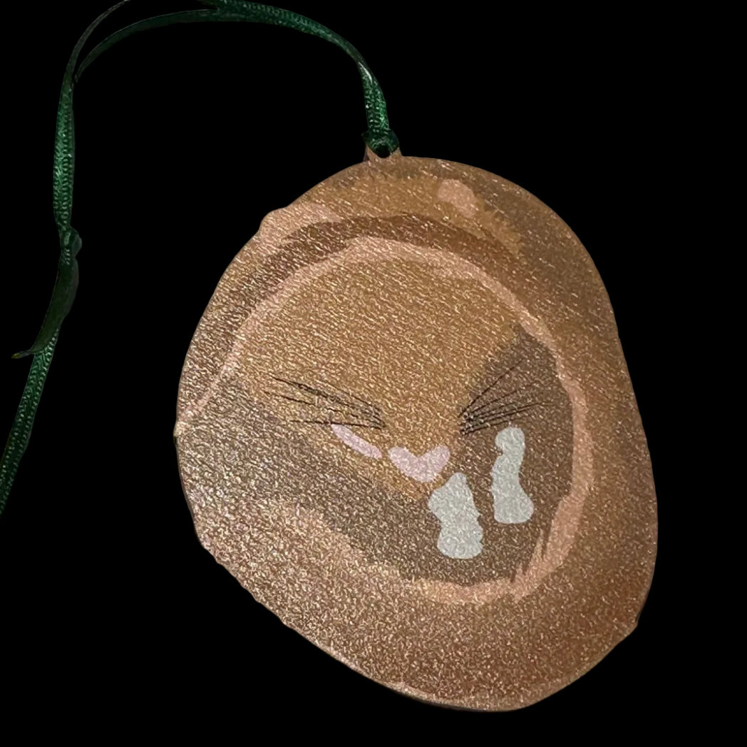 Dormouse shaped wooden hanging decoration with a green ribbon on a white background
