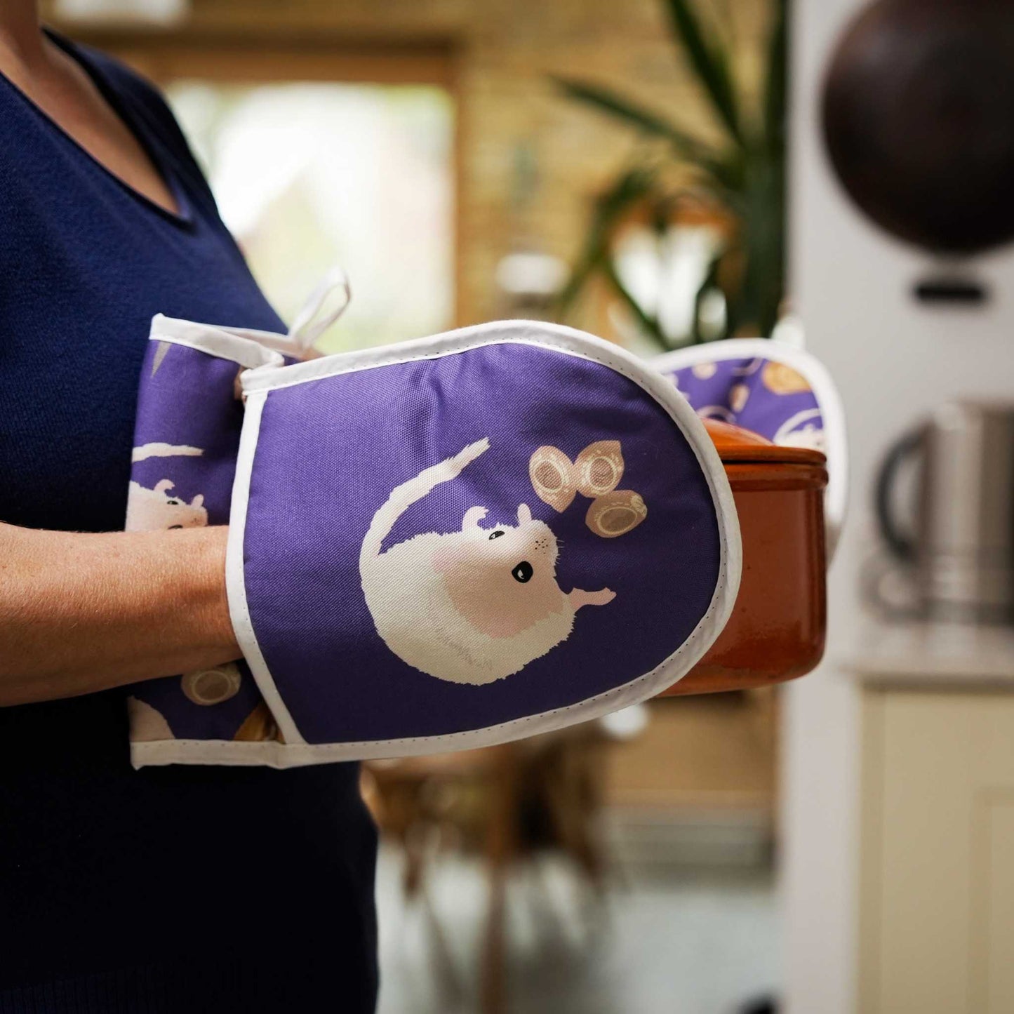 dormouse oven gloves shown being used by person carrying casserole dish