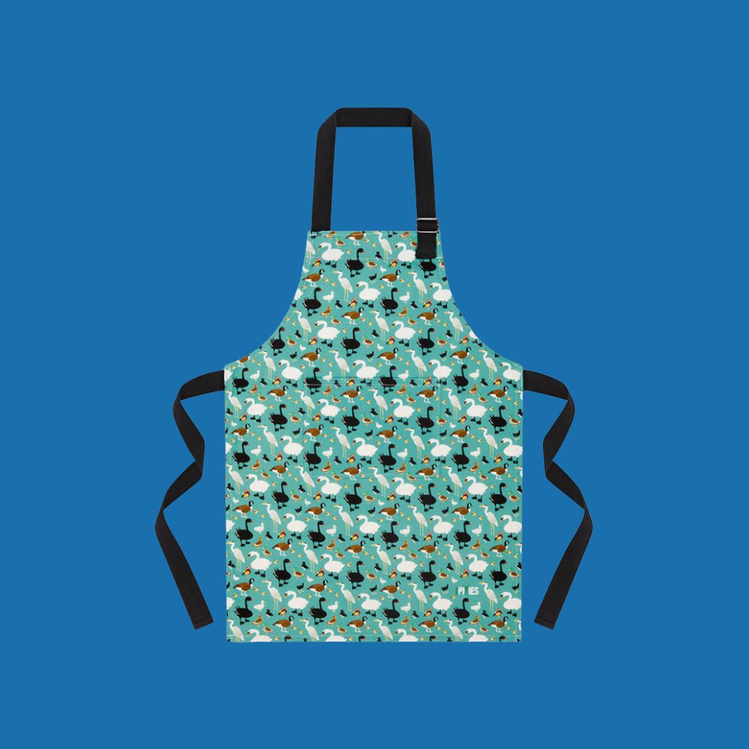 colourful child sized cotton apron with ducks and geese and swans shown on blue background