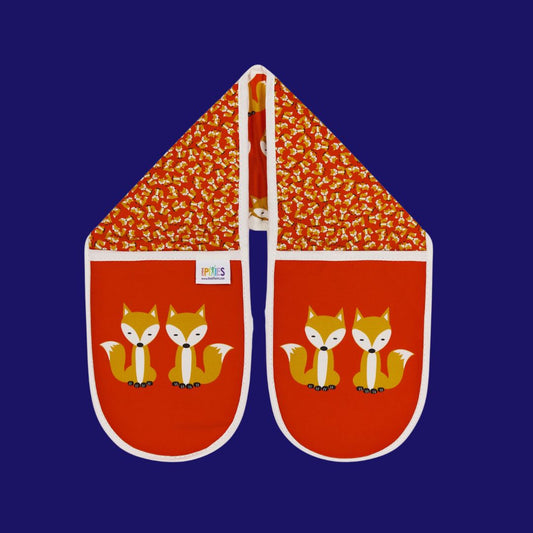 bright red colourful organic cotton oven gloves illustrated with fun fox design showing a parade of foxes on one side and a scatter of tiny foxes on the other. The main glove mitt features a bold print of a pair of sitting foxes