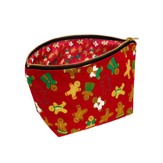 Red cosmetic bag with gingerbread man pattern on a white background, shown open to reveal printed waterproof lining