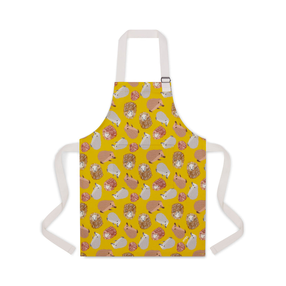 Yellow organic cotton apron featuring UmmPixies hedgehogs illustrations shown on younger child size suitable for up to 5 years old
