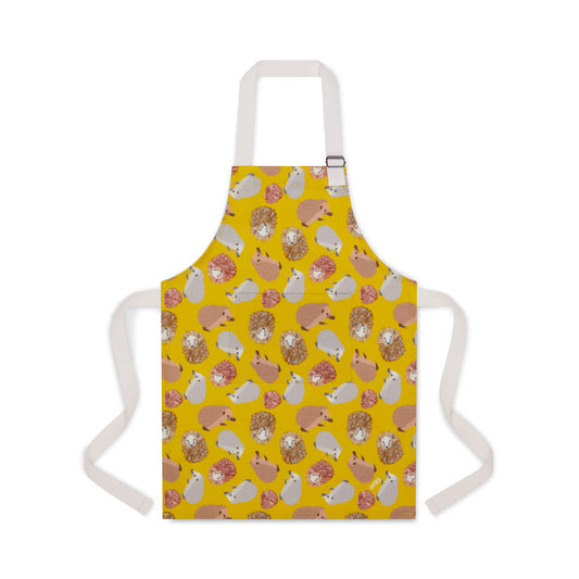 Yellow organic cotton apron featuring UmmPixies hedgehogs illustrations shown on younger child size suitable for up to 5 years old