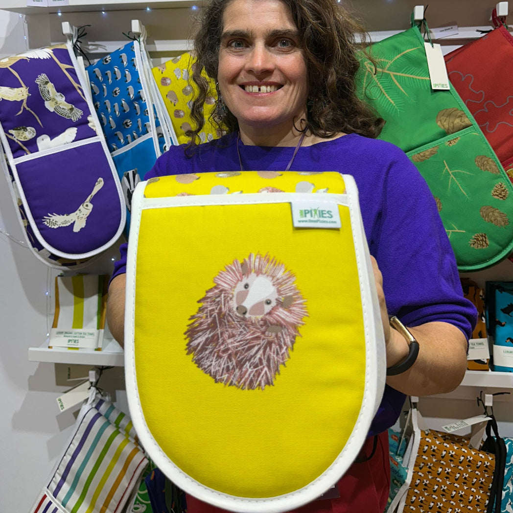Paula holding sunny yellow hedgehog oven gloves