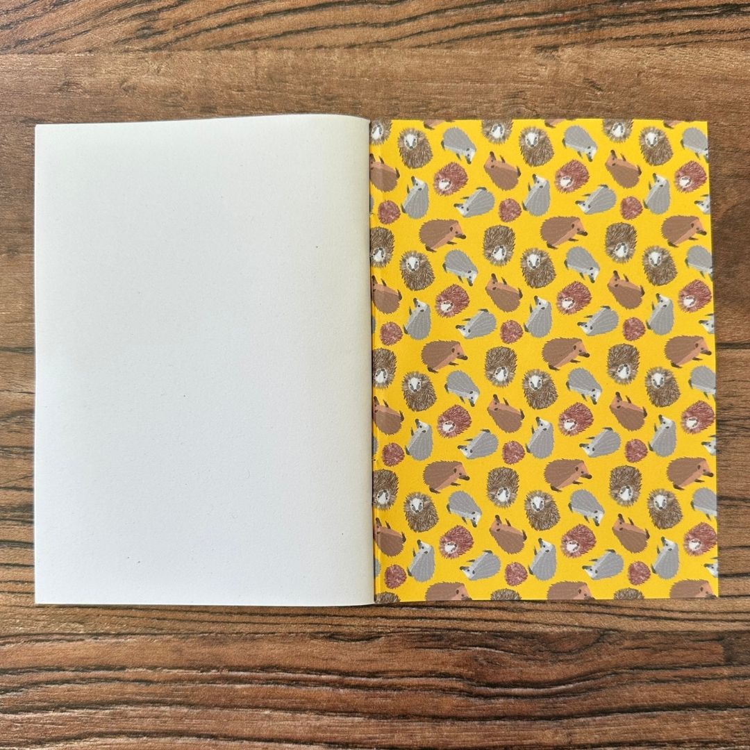 Hedgehog notebook inside back cover on wooden table