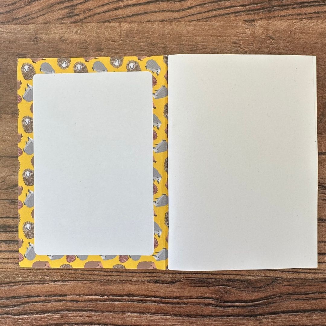 Hedgehog notebook inside front cover on wooden table