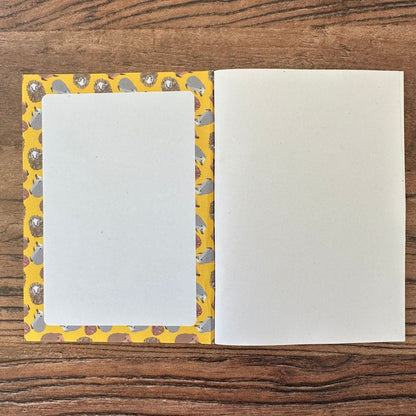 Hedgehog notebook inside front cover on wooden table