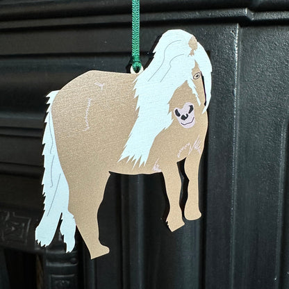 shetland pony wooden hanging decoration shown hanging from corner of a cast iron fireplace
