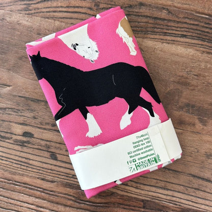 Bright Pink Horses illustrations organic cotton tea towel on a wooden table