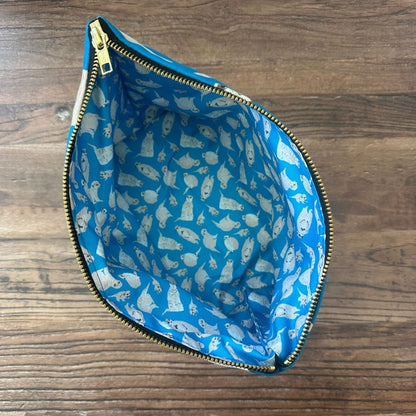 Bright blue Meerkats illustrated really useful bag shown from above with zip open and waterproof printed lining visible