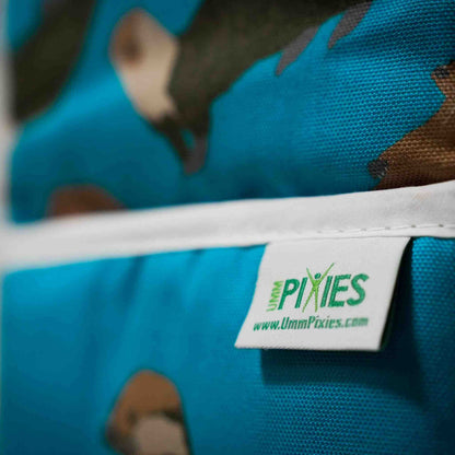 Close up of Bright petrol blue Otter oven gloves branded UmmPixies label