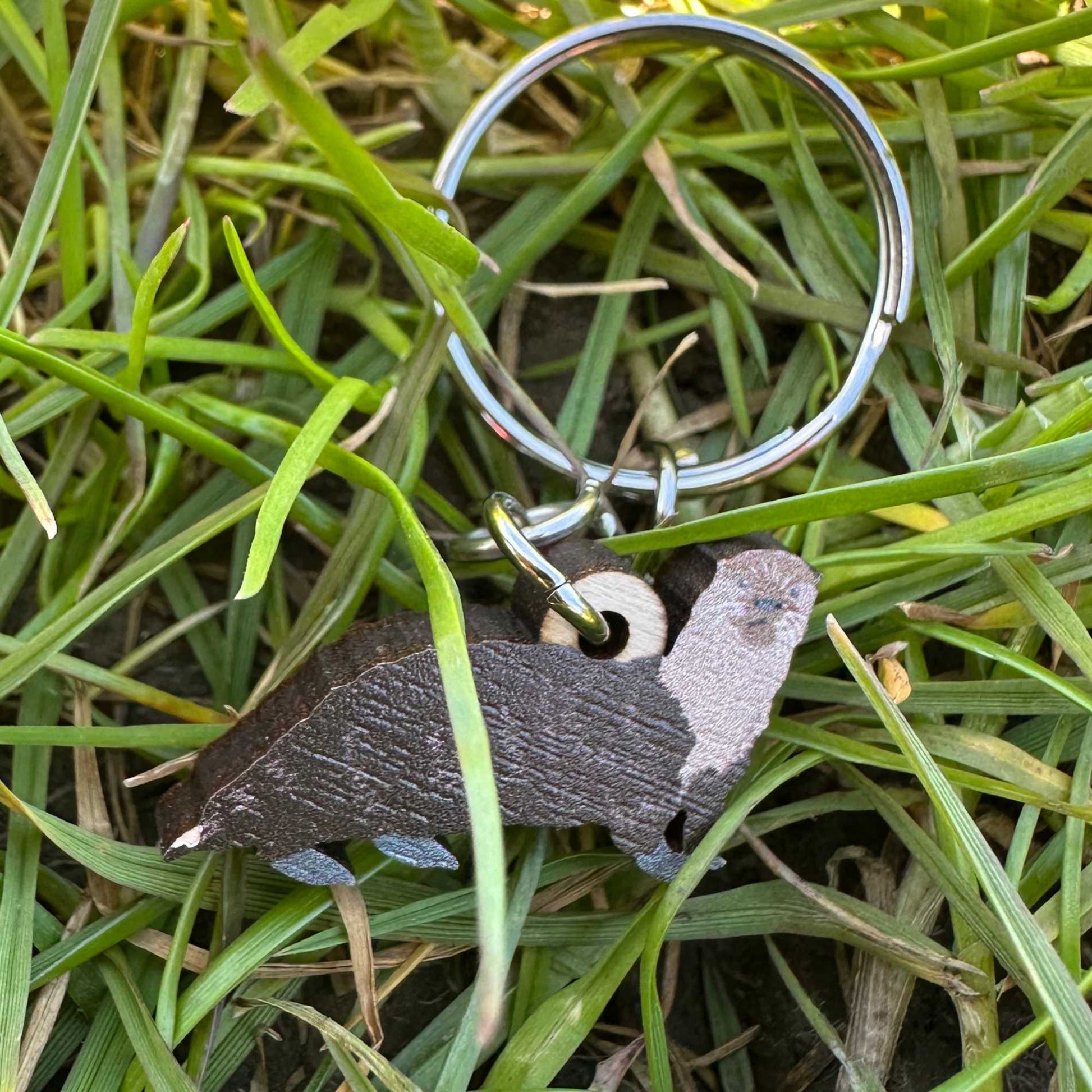 Keychain with otter design on grass