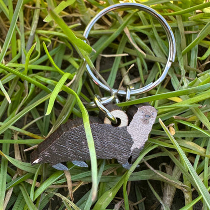 Keychain with otter design on grass