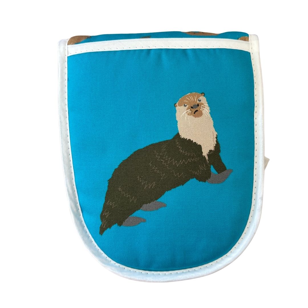 close up of right mitt of oven gloves with otter illustration on a white background