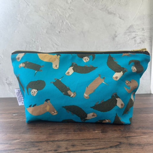 Petrol Blue Otters illustrated really useful bag shown with zip closed on wooden surface