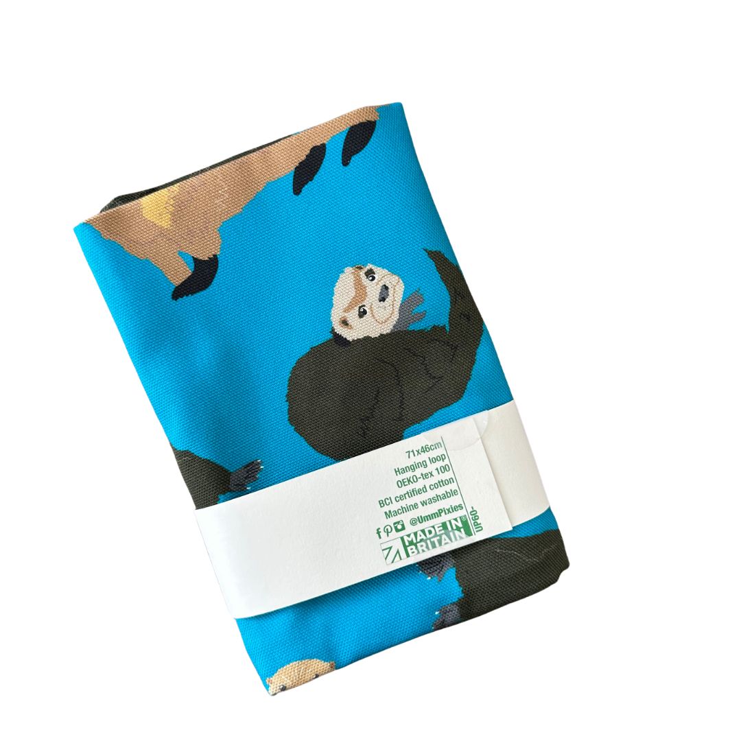Petrol blue otters design organic cotton tea towel- reverse shown in packaging