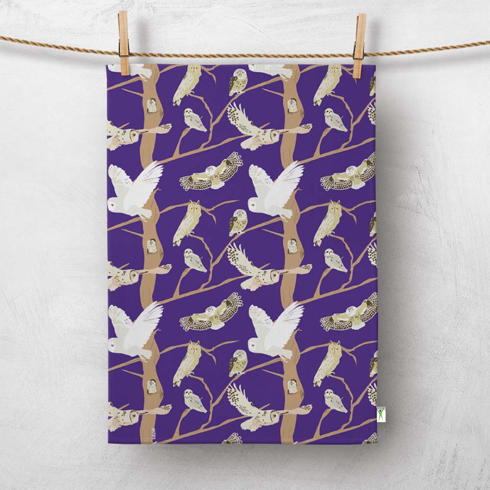Purple tea towel with British Owls pattern hanging on a line. Great gift for bird lovers and wildlife fans, illustrations include the barn owl, tawny owl and more